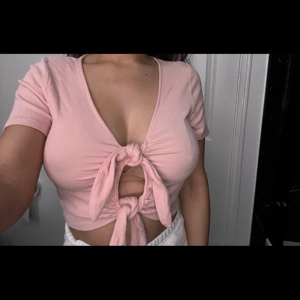 Pink crop top with two ties at the front.